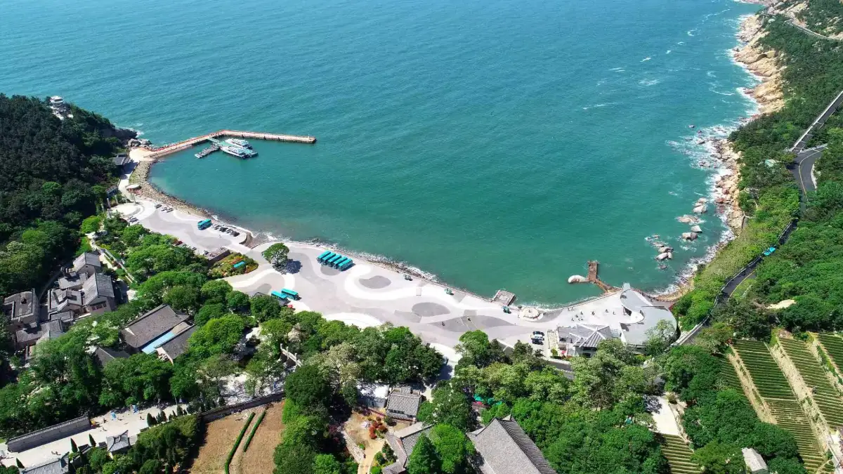 Aerial view of a turquoise bay and pier on the Laoshan coast