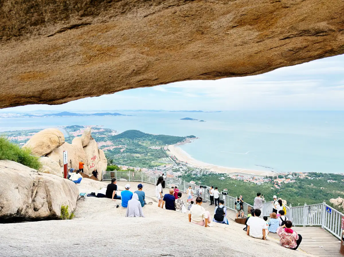 View over Yangkou bay framed beneath a granite overhang