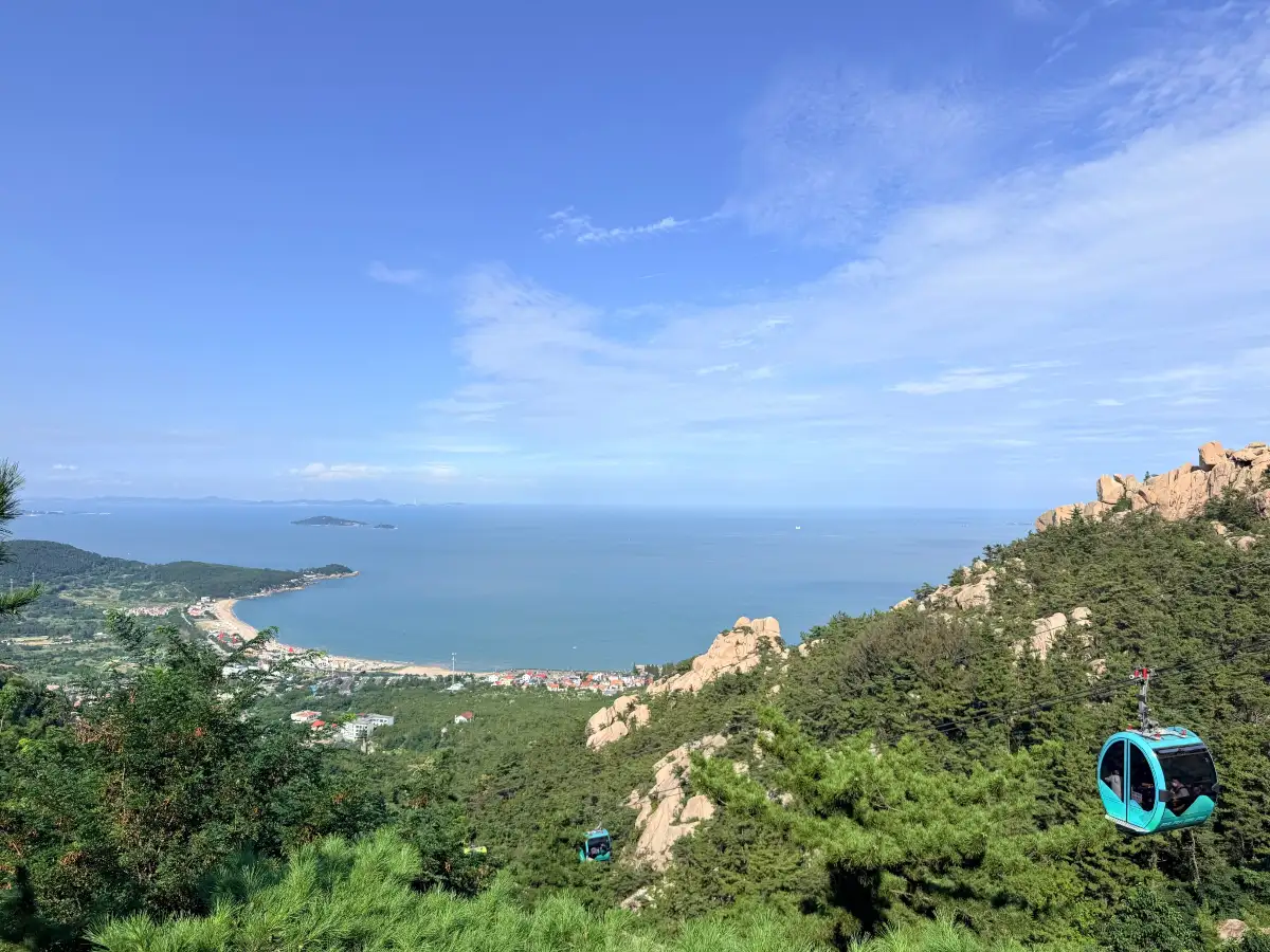 Coast, beach and cable-car pod seen from the Laoshan hills